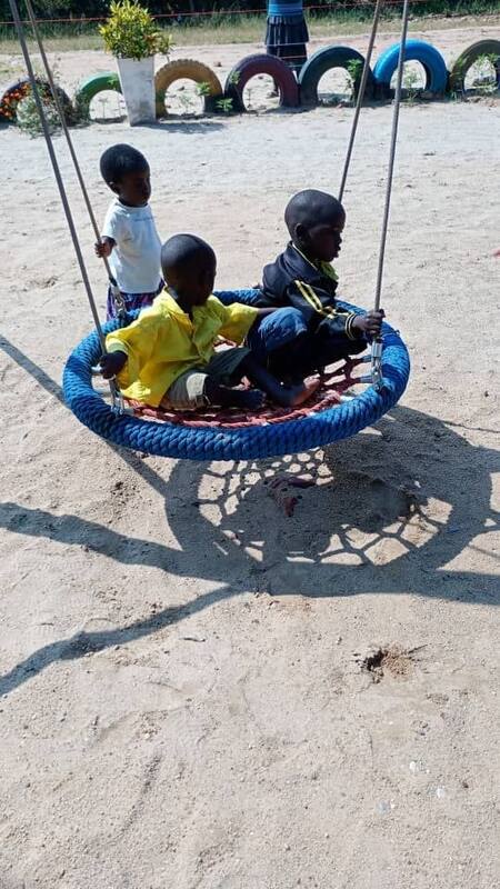 Children on the play yard swing