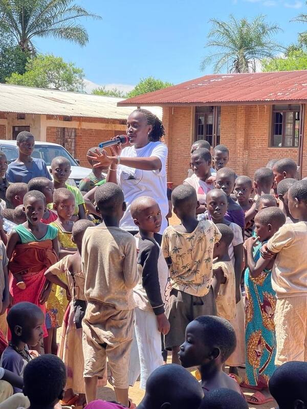 A TMDI team member speaking with a community gathering