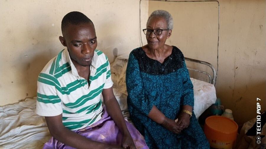 A caregiver visiting a young man receiving hospital support